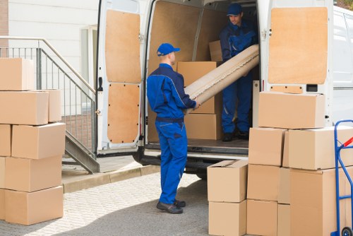 Professional removal team handling boxes in St Pancras