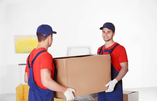 Moving trucks and professional movers assisting with a household relocation in Dulwich.