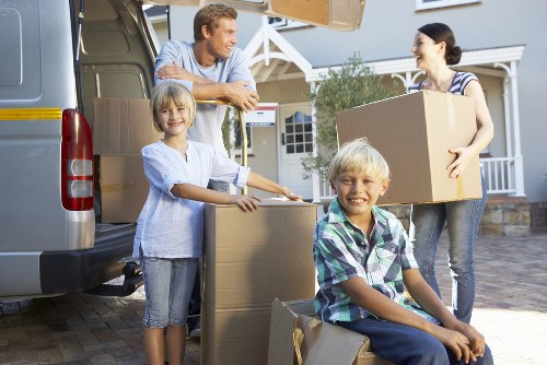 Movers handling furniture disassembly in a De Beauvoir Town home